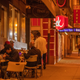 Patrons have lunch outside a restaurant as smoky skies from the northern California wildfires casts a reddish color around noon in San Francisco, September 2020